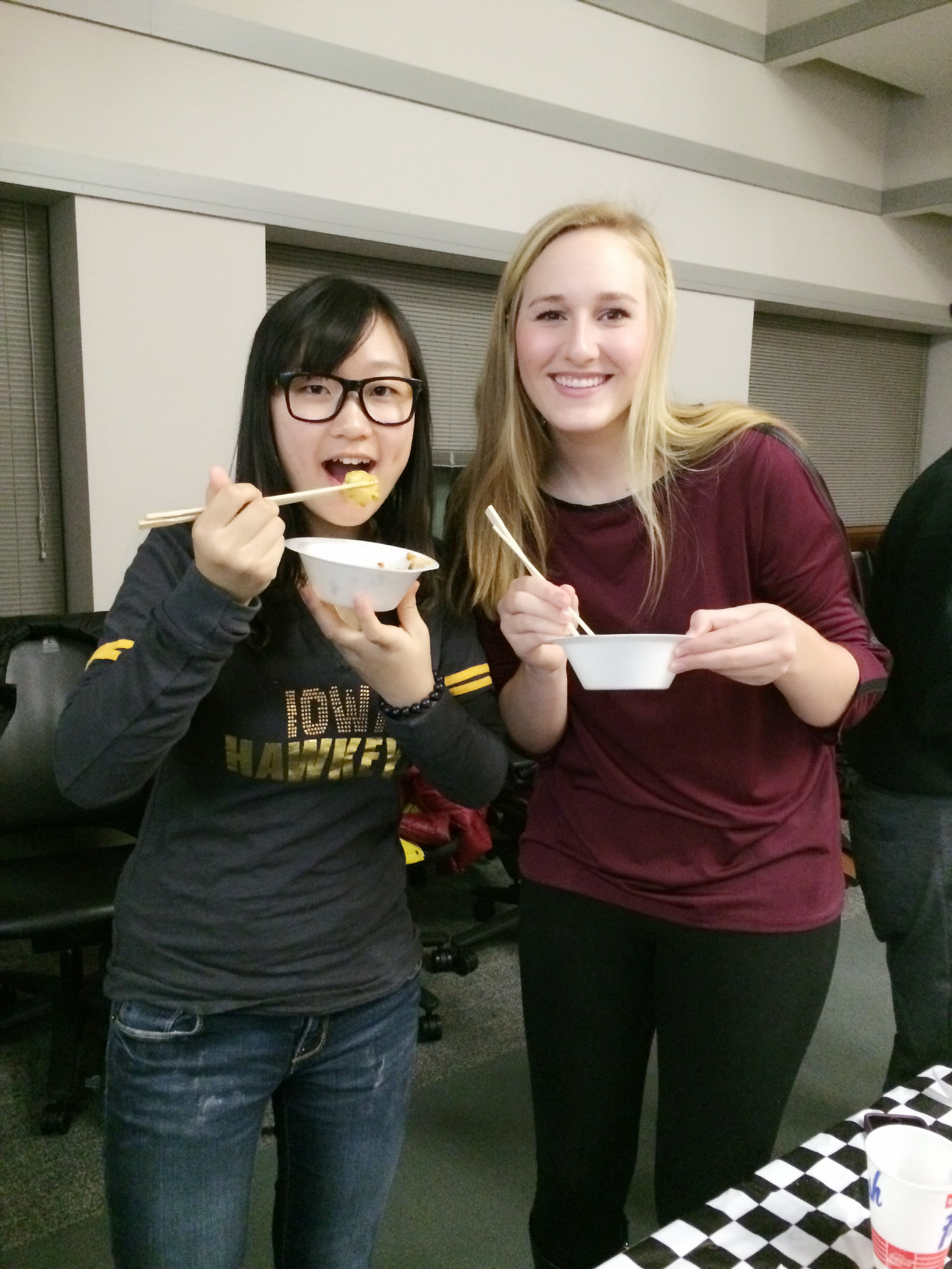 students at Chinese New Year celebration eating noodles