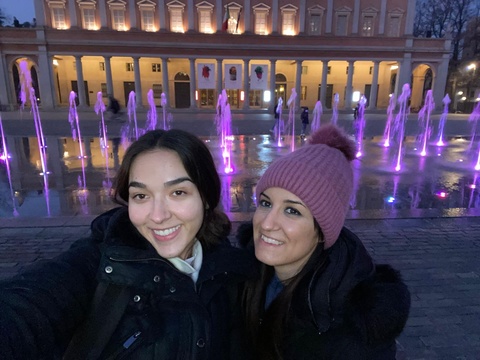 Mariana Garces Grajales with friend in front of purple lights and fountain
