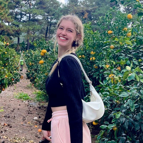 student smiling in orange grove