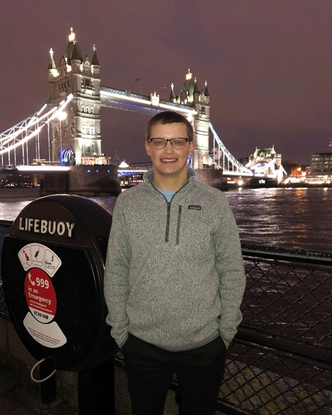 Kevin McKee standing in front of Tower Bridge, London
