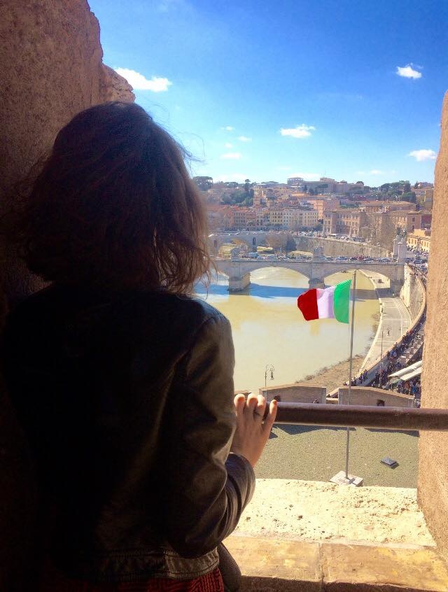 Hannah looking out a window in Italy