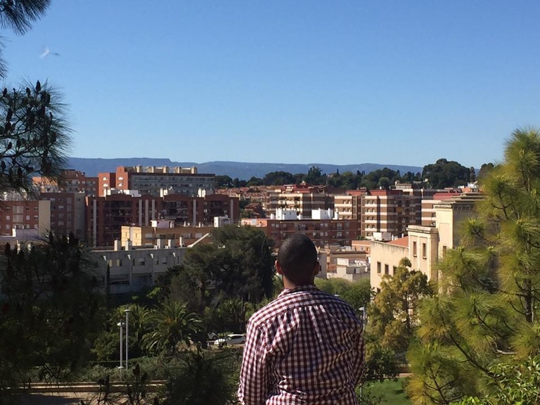 Marcus overlooks a city skyline of Tarragona Spain