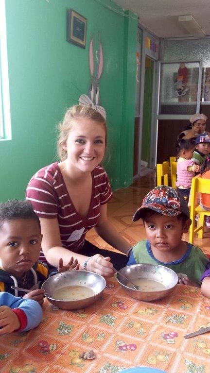 Zoe Feldmann smiles with children in an Ecuadorian daycare during the 2015 service trip. Photo courtesy of the UI Alumni Association.