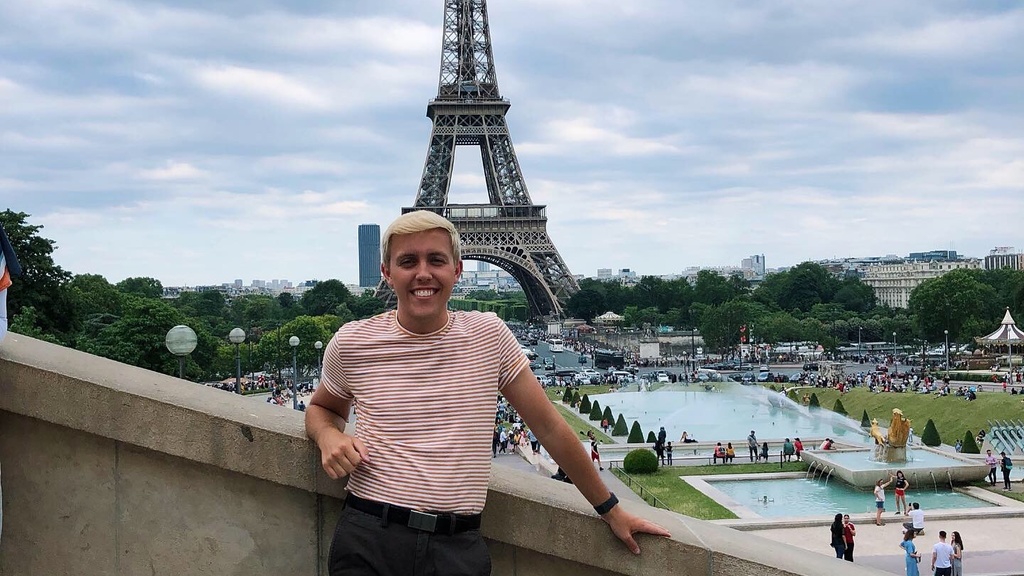 student in Paris in front of Eiffel Tower