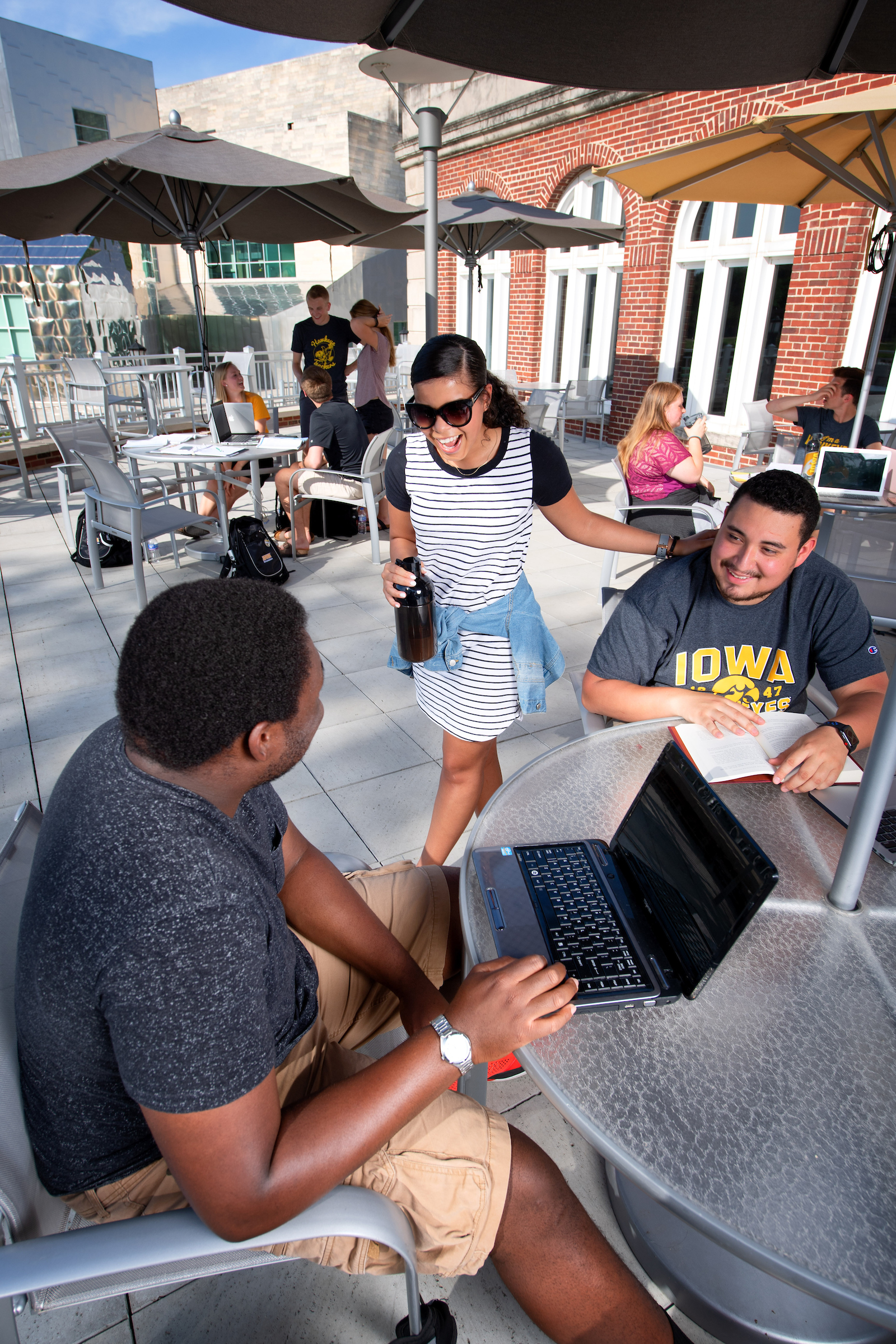 Students talking at table outside at IMU