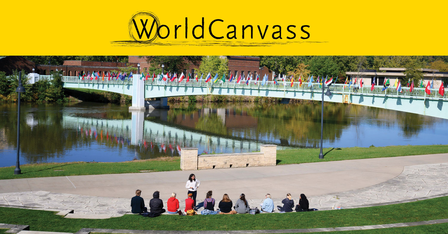 WorldCanvass students looking at bridge of flags on UI campus