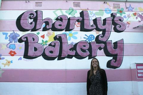 Standing in front of Charly's Bakery sign