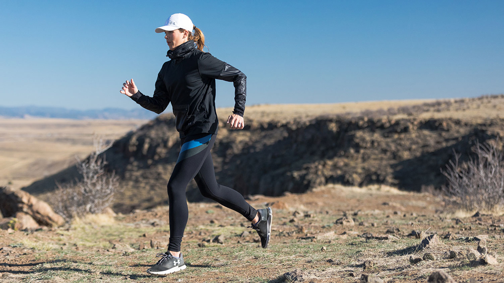 woman running through rough terrain
