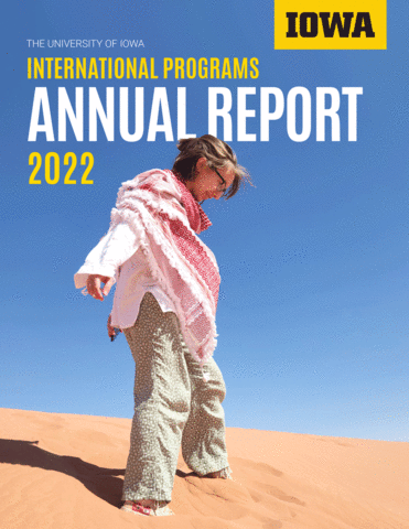 student looking down at desert sand and International Programs Annual Report 2022