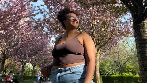 student posing under blossoming trees