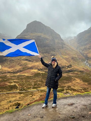 Payton Pangburn holding a Scottish flag in Glencoe, Scotland