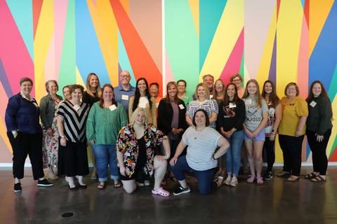 Global Education Institute participants in front of colorful mural at Stanley Museum of Art