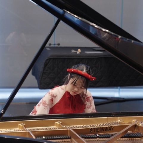 Duong (Jun) Le playing piano, close up