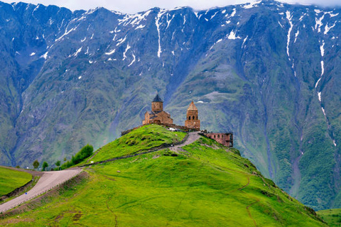 Castle in front of Greater Caucasus snowy mountain range