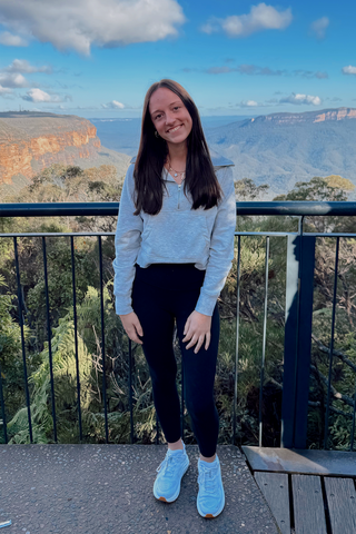 Adi standing in front of a view in Australia