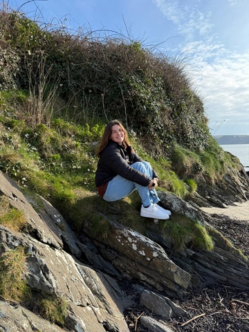 Analia sitting on a rock in Ireland