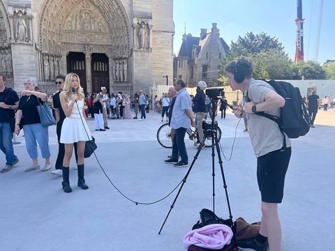 Sean Keene behind the camera filming people in Paris
