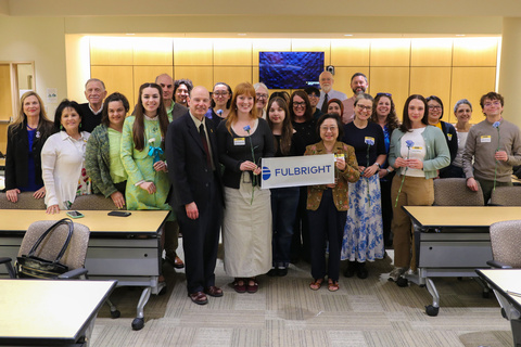 Group of faculty, staff and students holding Fulbright sign