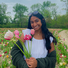 student smiling with tulips