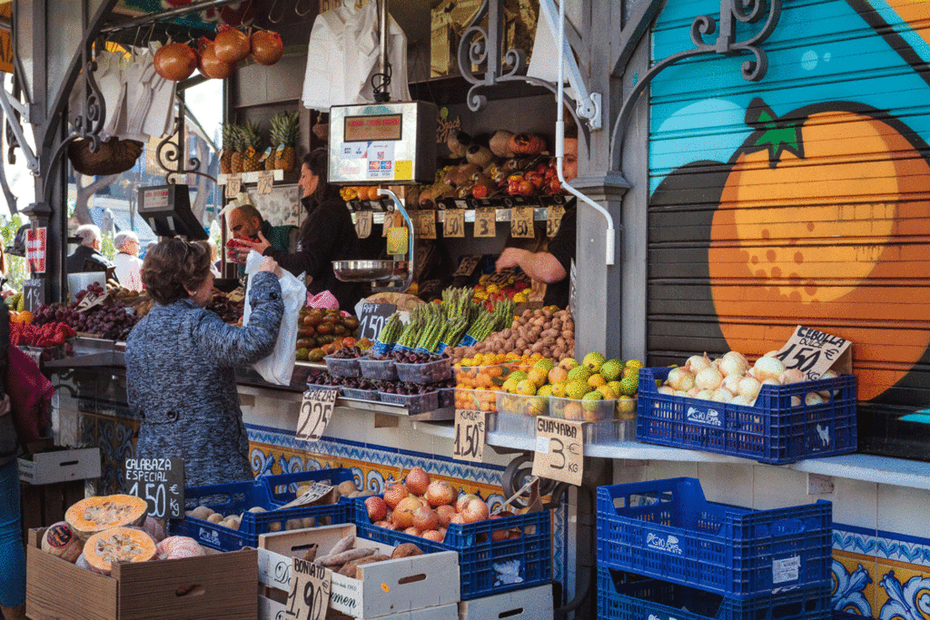 woman in front of produce market in Valencia Spain