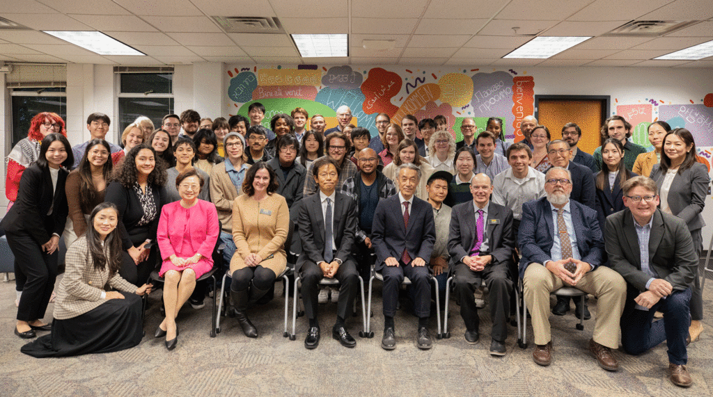 Japanese ambassador sitting among many UI students, faculty and staff