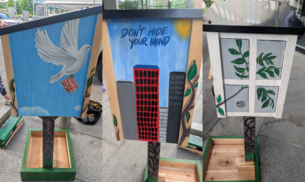 painted dove clutching diary, painted red building, painted window with tree branch outside it