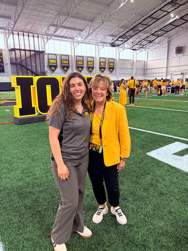 student standing with the president of the university