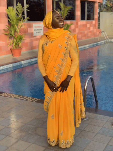 Amani Ali in India wearing yellow sari