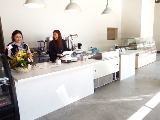 Jolly Pan, left, and Tancy Zhou, right, stand at the counter of the new Cliche Patisserie 