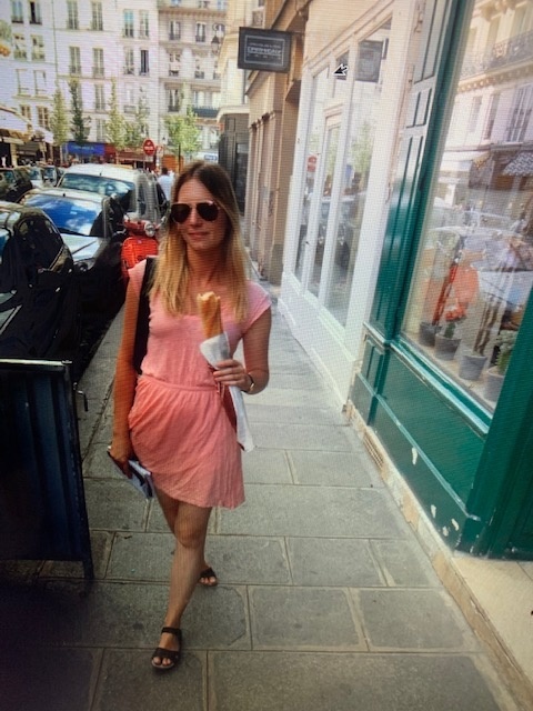 Elisha Smiley during her study abroad experience in France—enjoying a baguette during a stroll