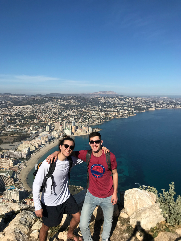 two students with city view behind them