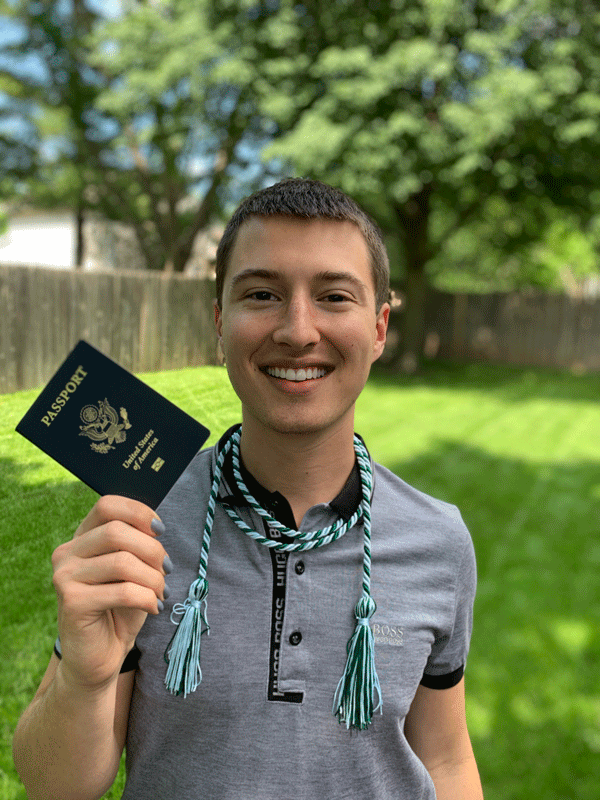 Jacob Gordon with study abroad cord and passport in hand