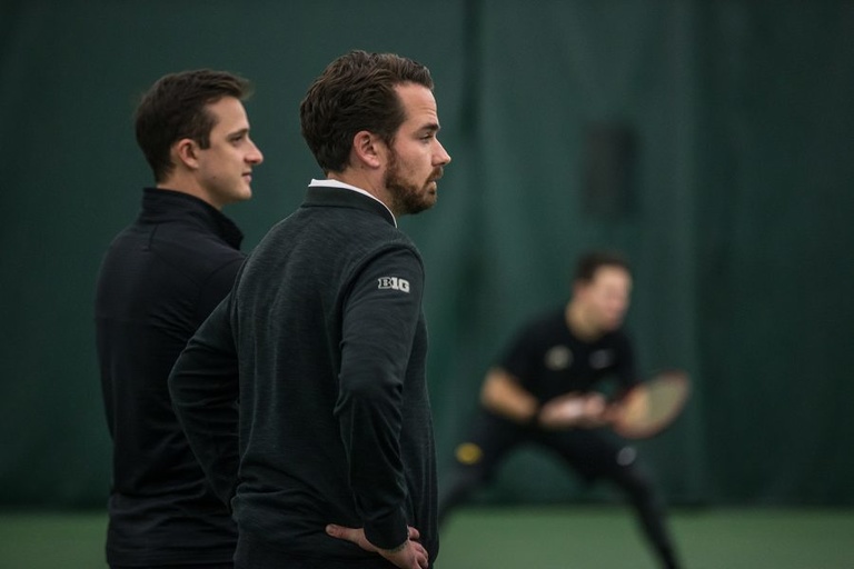 Iowa coach Ross Wilson watches his team during a men's tennis match between Iowa and Marquette on Saturday, January 19, 2019. The Hawkeyes swept the Golden Eagles, 7-0.