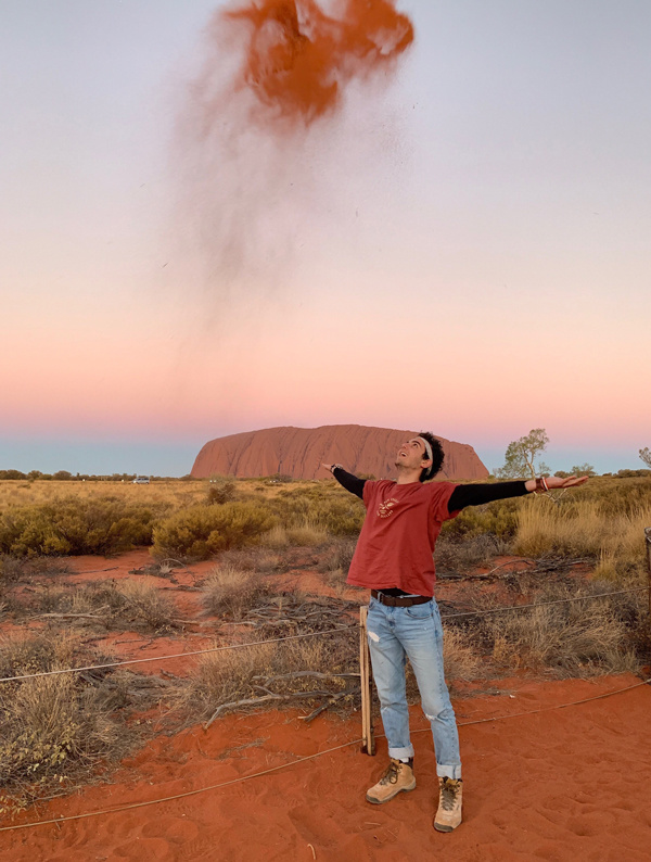 Omar Khodor throwing sand in the air in Australia