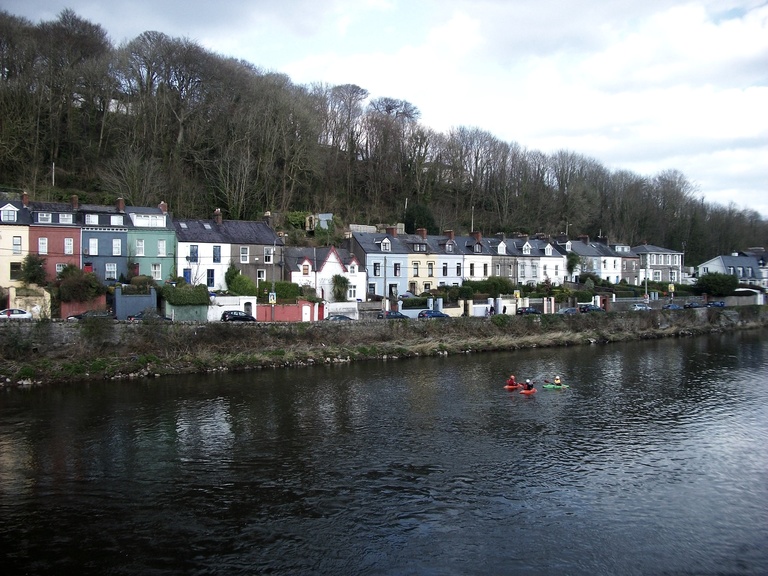 Colorful houses and kayakers along the River Lee