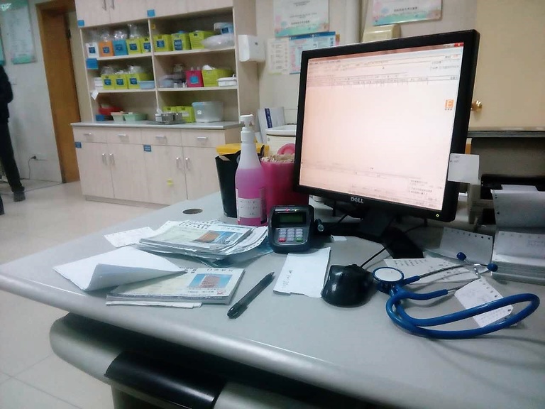 In China, patients still use paper medical booklets (on the left of the desk).