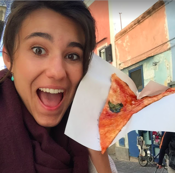 Maggie holding a slice of pizza