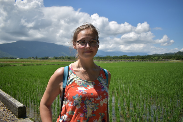 Sylvia posing in front of a rice field in early fall in Hualien, Taiwan