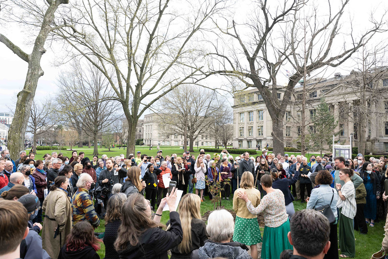 The community surrounds the tree.