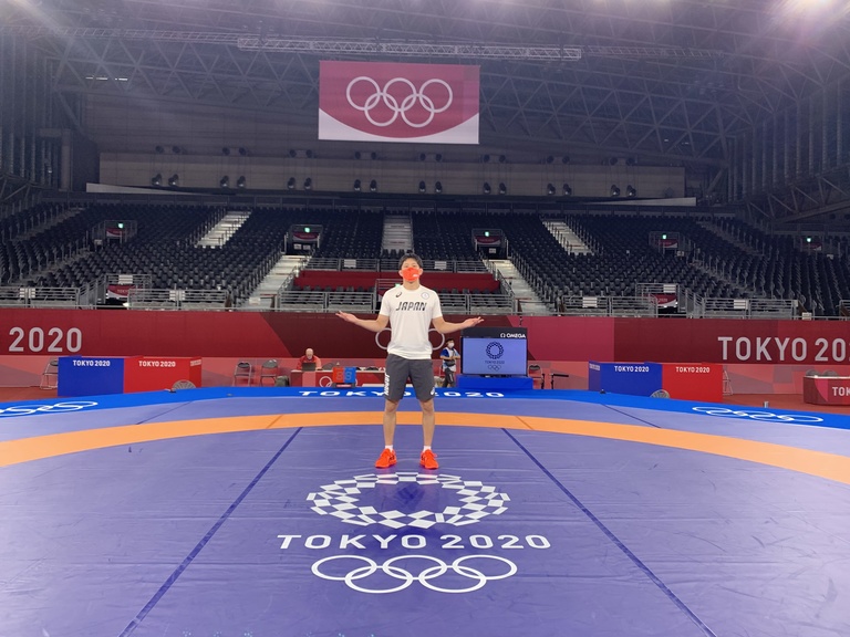 Keisuke standing in the middle of the 2020 Tokyo Olympic wrestling mat