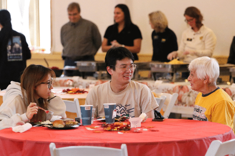 two students and a community member talking