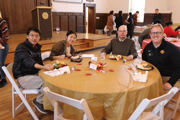 people sitting at table smiling