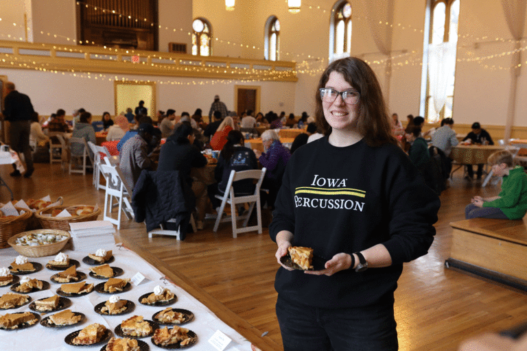 one student with Hawkeye sweatshirt smiling