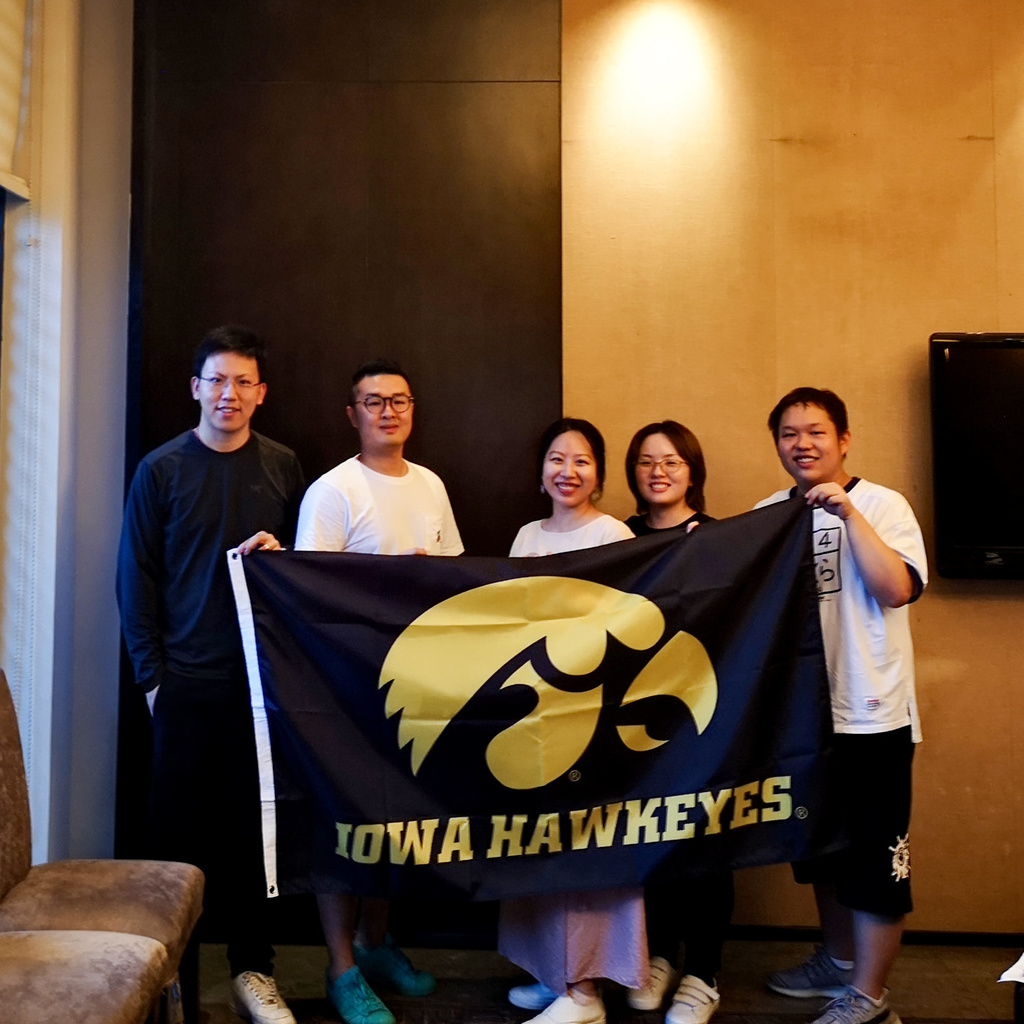 International alumni group in Wuhan, China holding Iowa flag