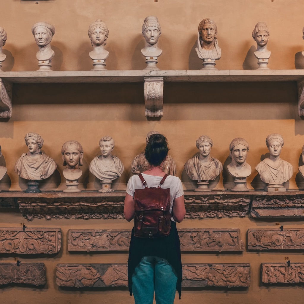 Woman looking at Roman busts in the Vatican Museum 