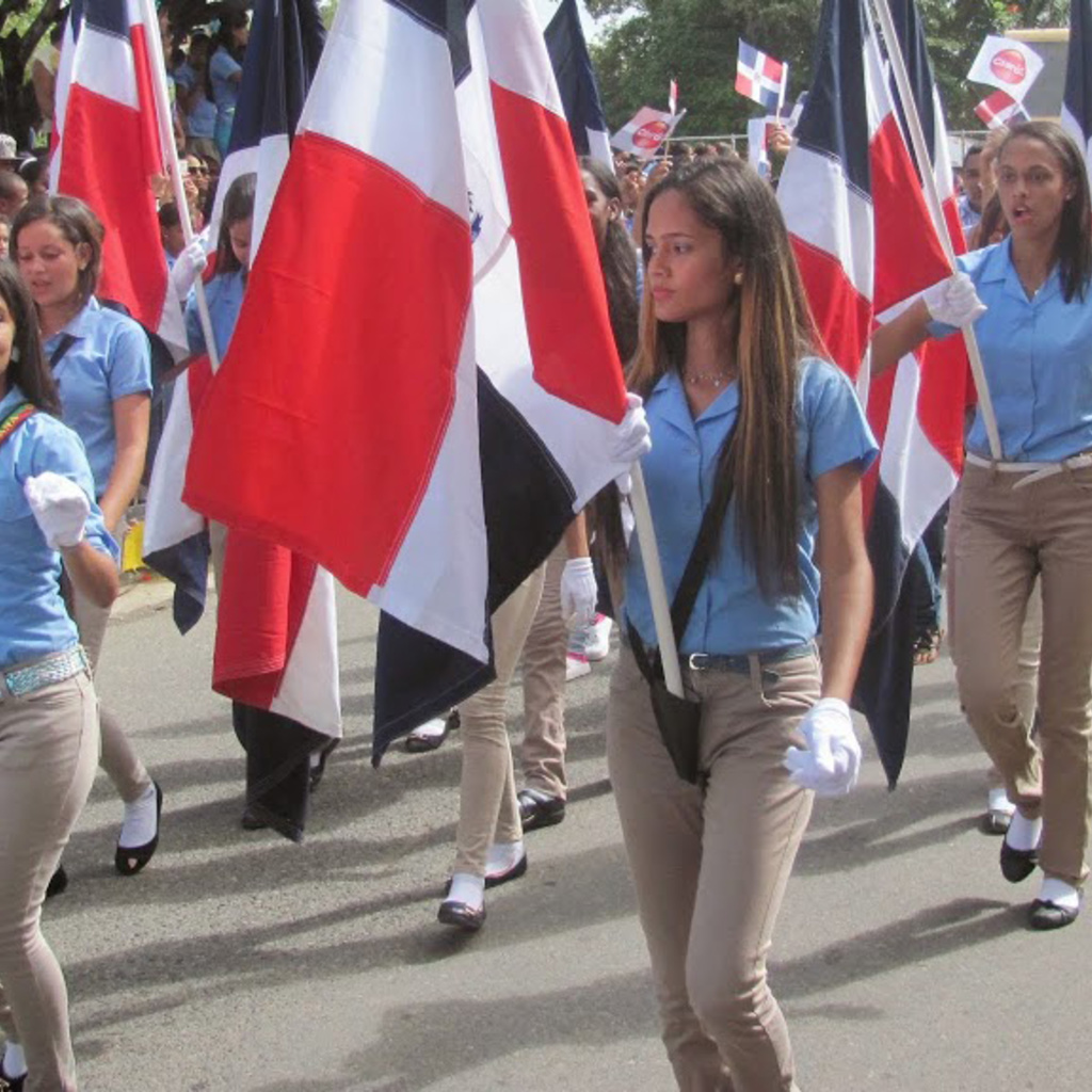 Women walking with flags in the Dominican Republic