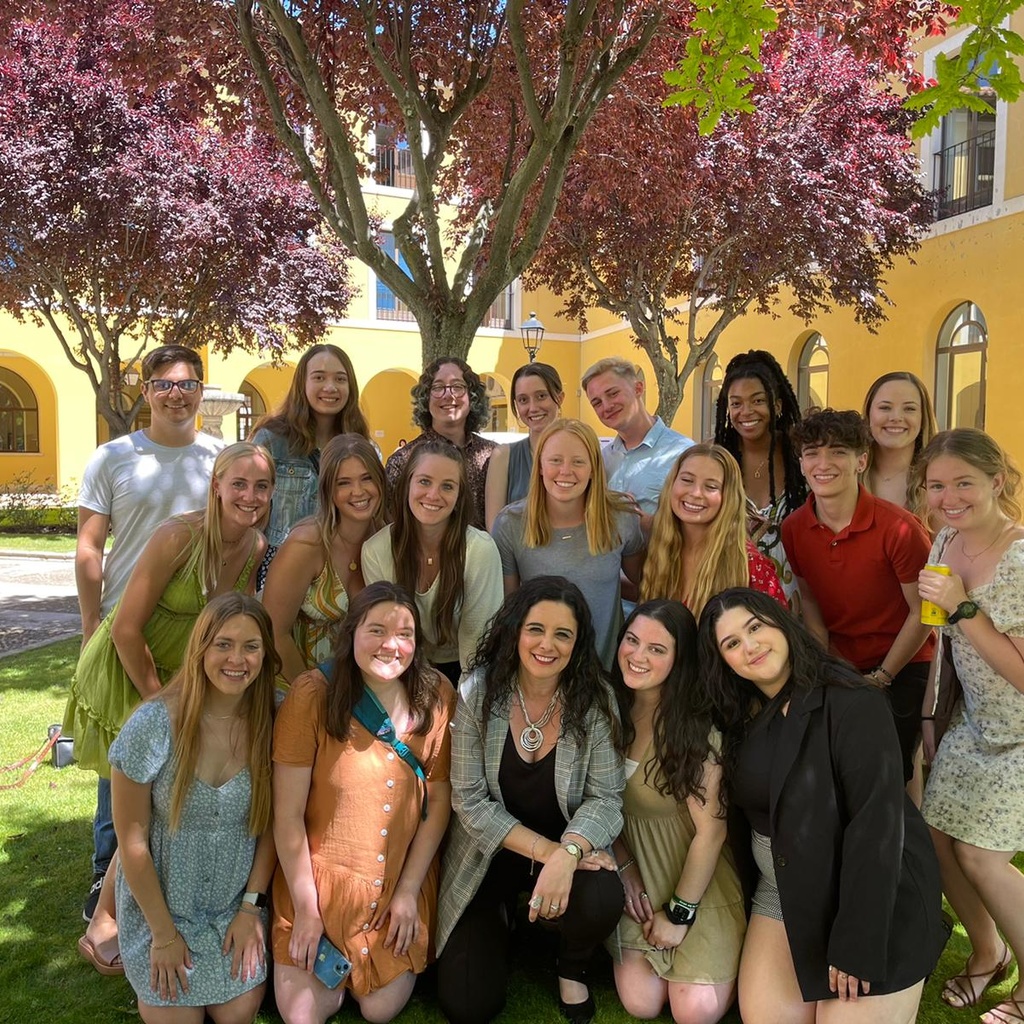 Students on the Iowa Hispanic Institute program posing in front of flowering tree