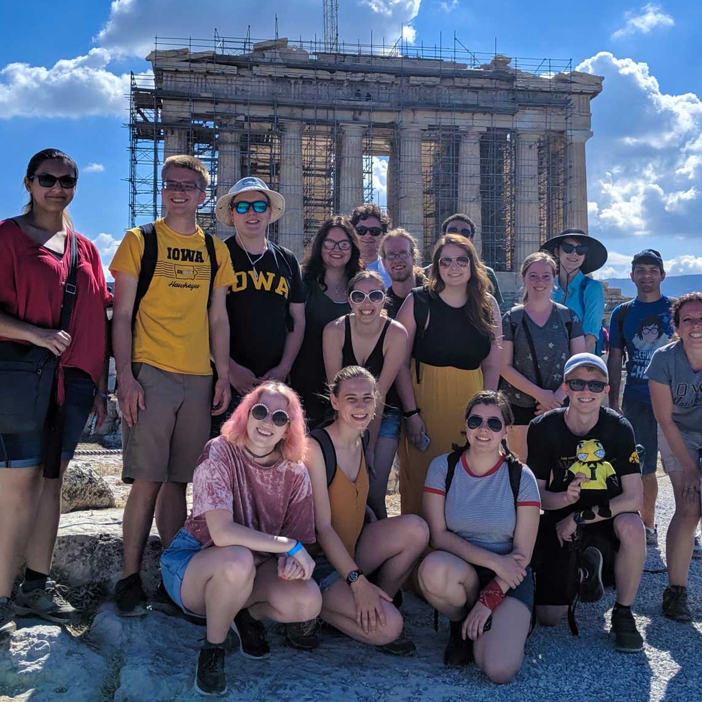 students wearing hawkeye shirts in front of Greek temple