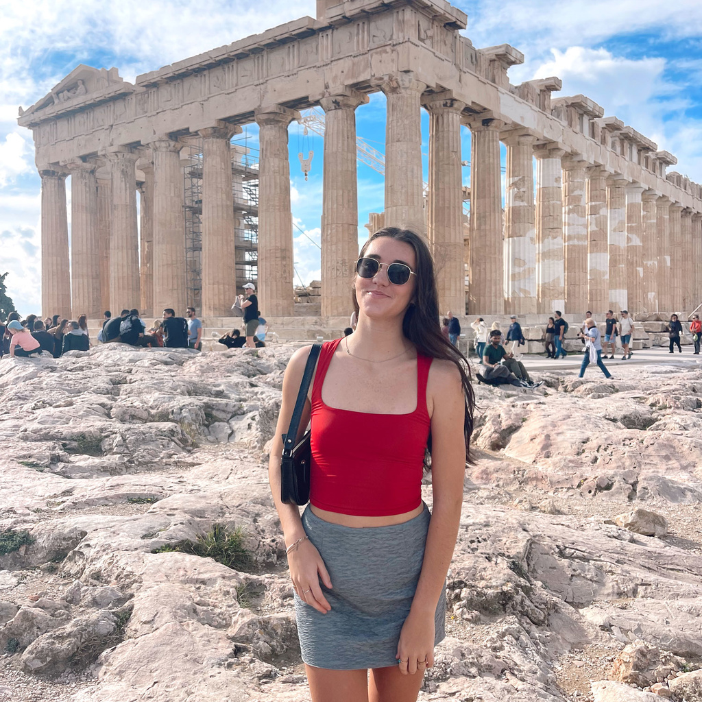 Anna Neslund in Greece standing in front of ancient structure with columns
