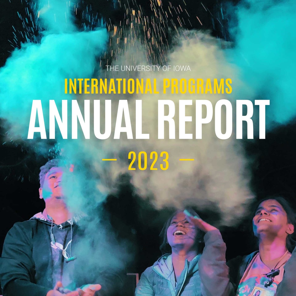 The University of Iowa International Programs Annual Report 2023 people looking up amidst a cloud of colorful dust